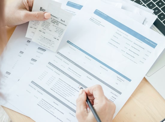 Person Filling Out Compliance Paperwork